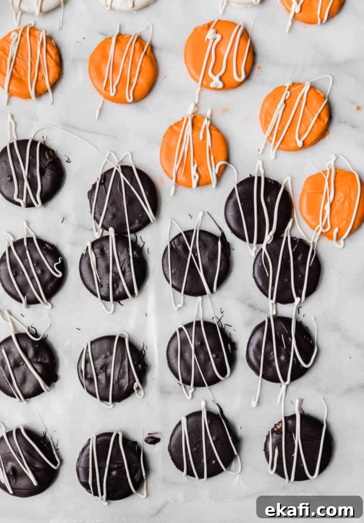 Haunted Snaps 8 White chocolate drizzled overtop black and orange covered Halloween Crackers for decoration.