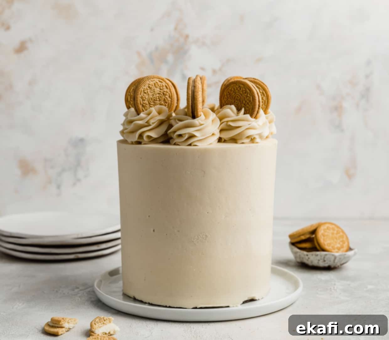Golden Oreo Dream Cake 2 A Golden Oreo Cake against a white and cream textured background.