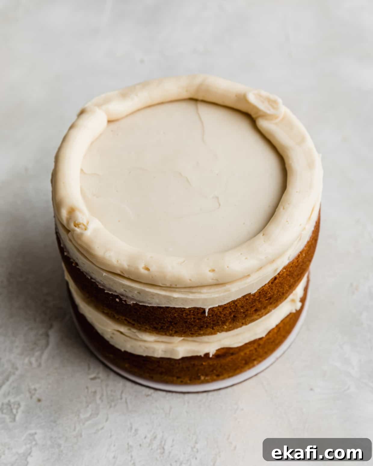 Golden Oreo Dream Cake 8 A Golden Oreo buttercream frosting piped along the perimeter of a cake layer.