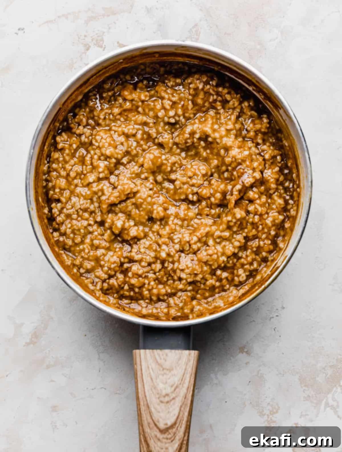 Autumn Pumpkin Spice Steel Cut Oats 6 The fully cooked and creamy Pumpkin Steel Cut Oats, still in a white saucepan, ready to be served, set against a clean white background.