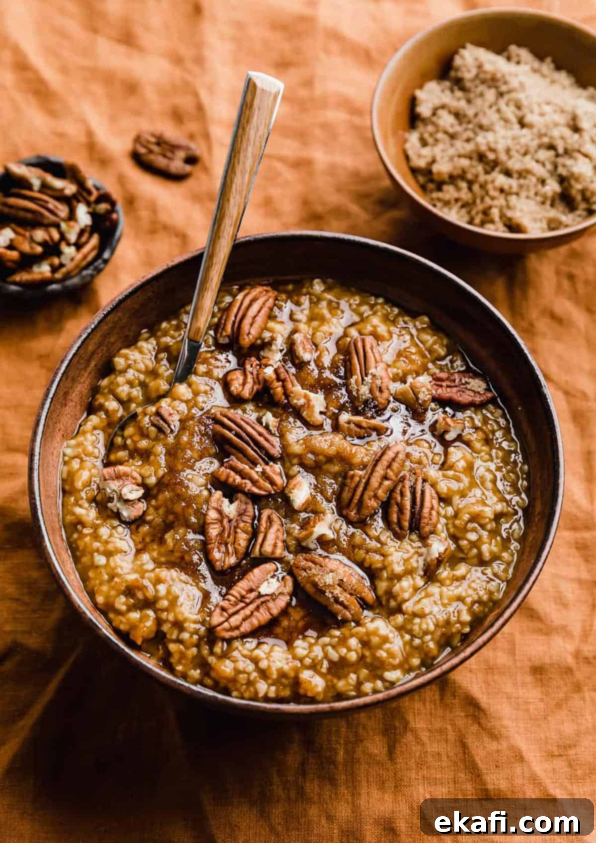 Autumn Pumpkin Spice Steel Cut Oats 8 A tantalizing bowl of Pumpkin Steel Cut Oats, generously topped with crunchy pecans and a sprinkle of rich brown sugar, ready to be enjoyed.
