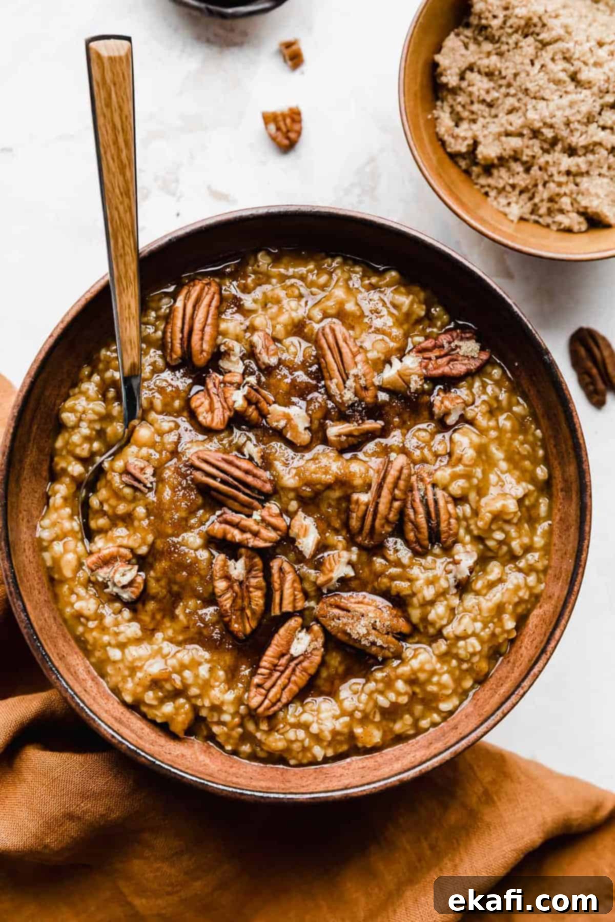 Autumn Pumpkin Spice Steel Cut Oats 9 A comforting bowl of Pumpkin Steel Cut Oats, artfully garnished with crunchy pecans and a touch of brown sugar, inviting you to indulge in a wholesome autumn breakfast.