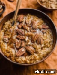 Autumn Pumpkin Spice Steel Cut Oats 10 A warm, inviting bowl of Pumpkin Steel Cut Oats, topped with a generous sprinkle of pecans and brown sugar, set against a cozy background.