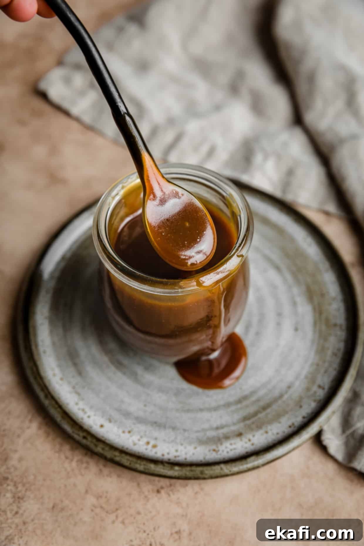 Salted Butterscotch Sauce 2 A spoon with Butterscotch Sauce on it, showcasing its luscious texture.
