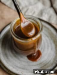 Salted Butterscotch Sauce 9 Salted Butterscotch Sauce in a jar on a gray plate, a perfect sweet topping.