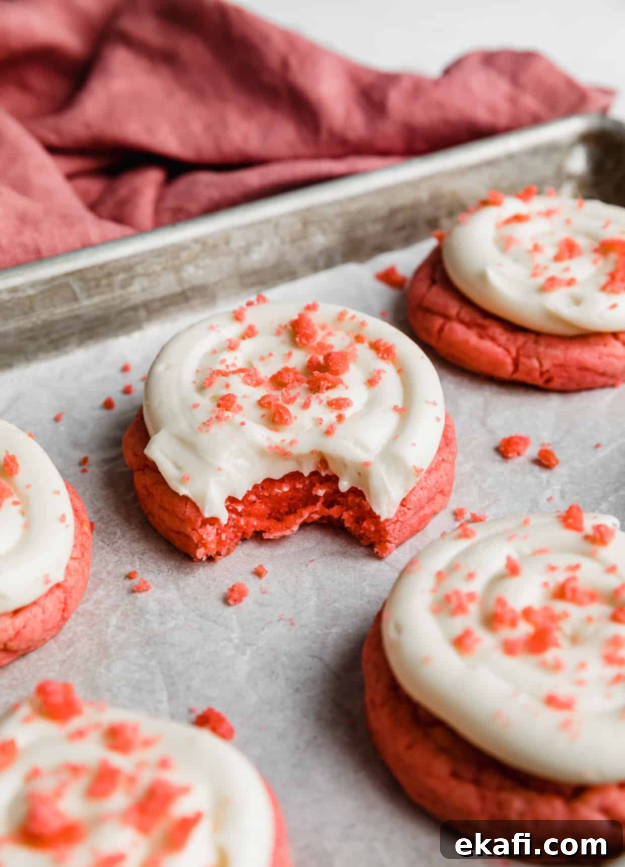 Blush Velvet Crumbl Delights 11 A bite taken out of a copycat Crumbl Pink Velvet Cookie.