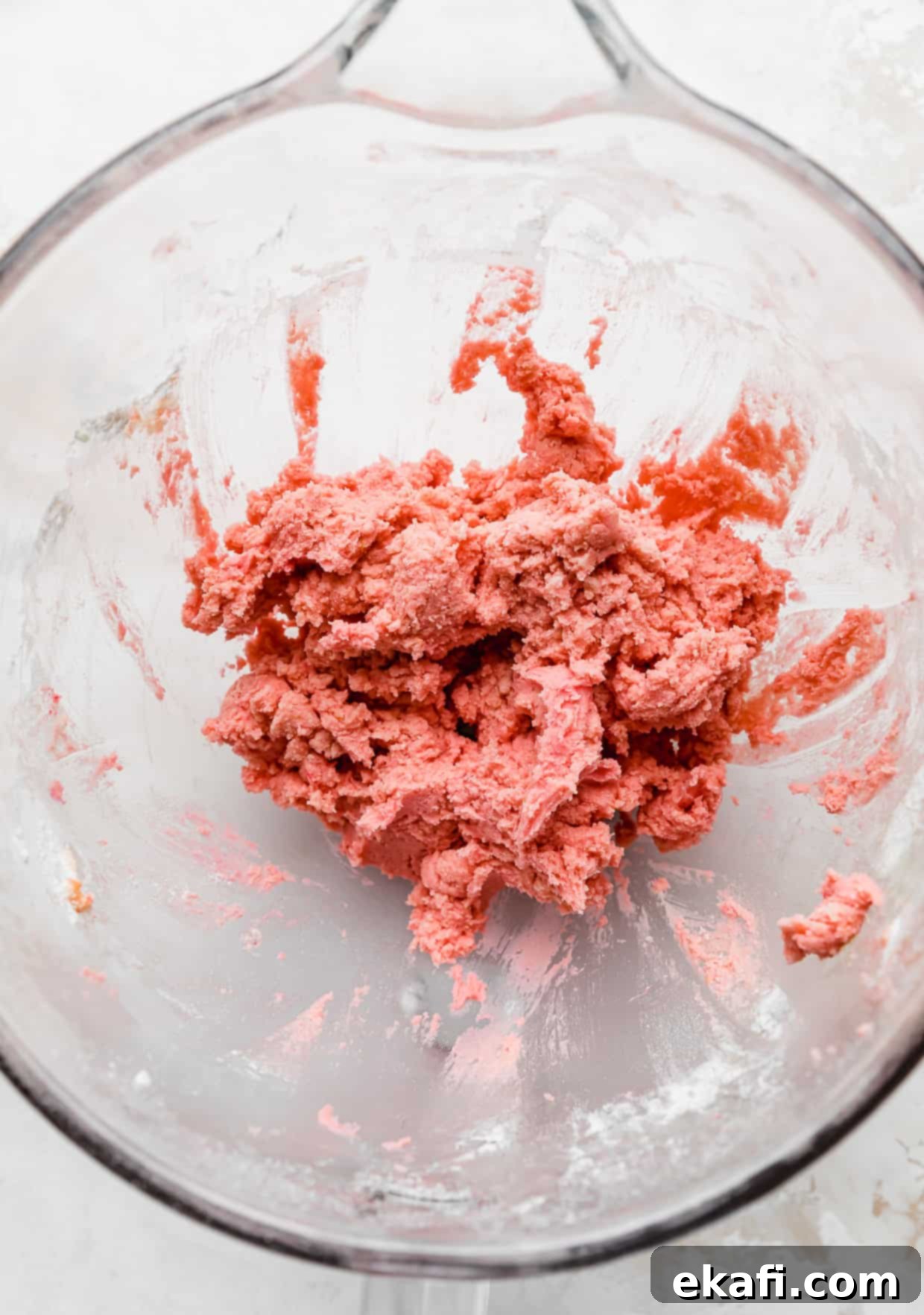 Blush Velvet Crumbl Delights 6 Pink Velvet Cookie dough in a glass bowl on a white background.