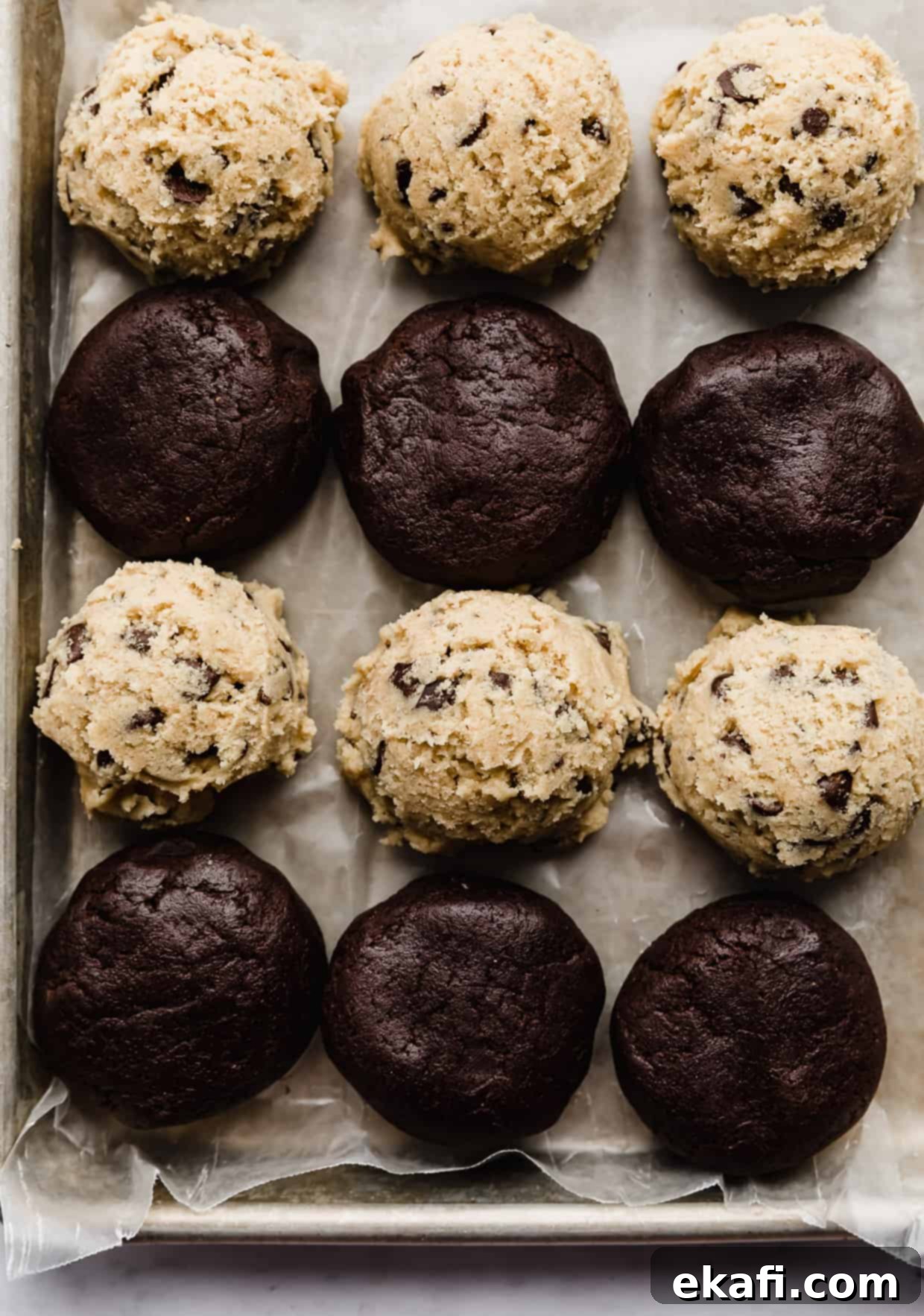 Freeze Cookie Dough for Instant Treats 4 Chocolate chip cookies and brownie cookie dough balls on a baking sheet.