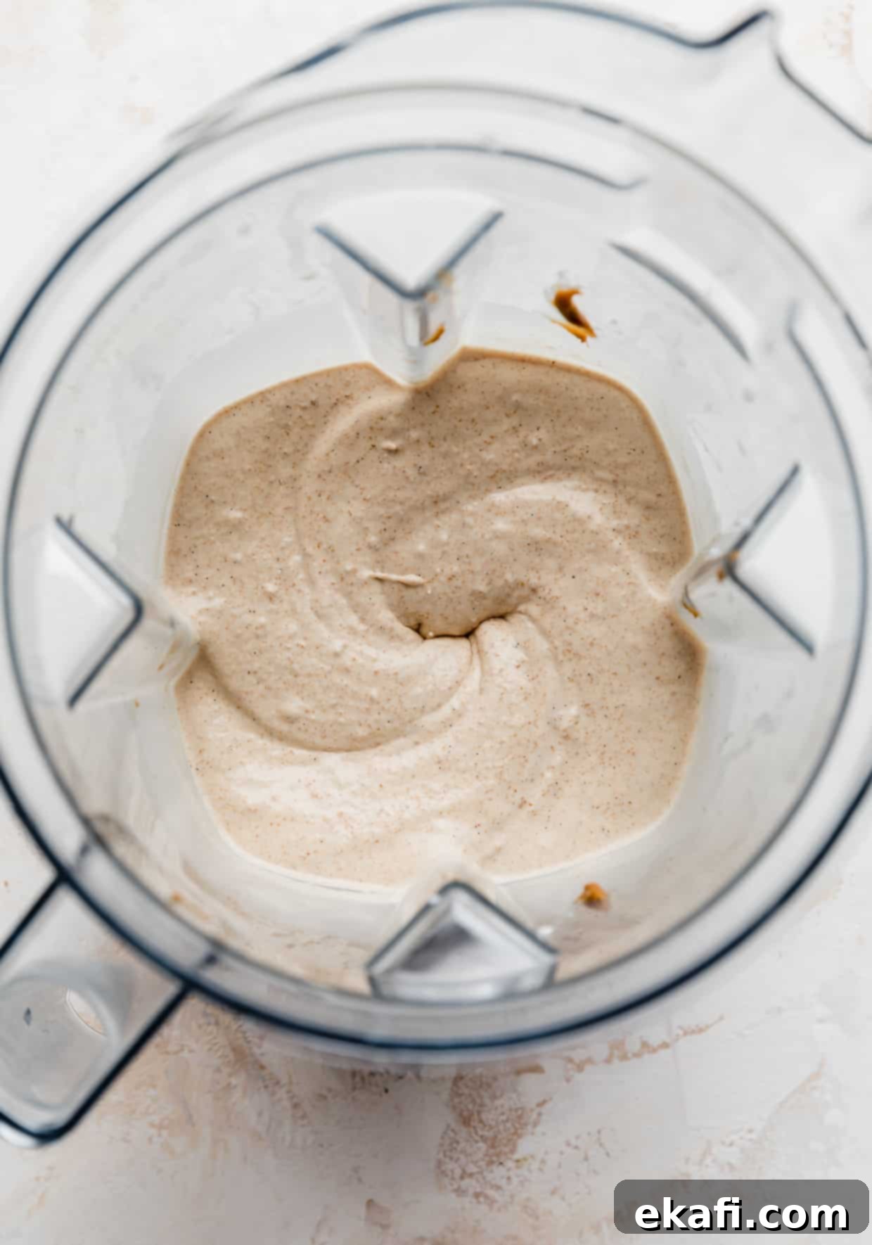 Biscoff Milkshake 5 A blender filled with a freshly blended, creamy Lotus Biscoff milkshake, showcasing its smooth texture and inviting golden-brown color, indicating it's perfectly prepared and ready to be poured into serving glasses.