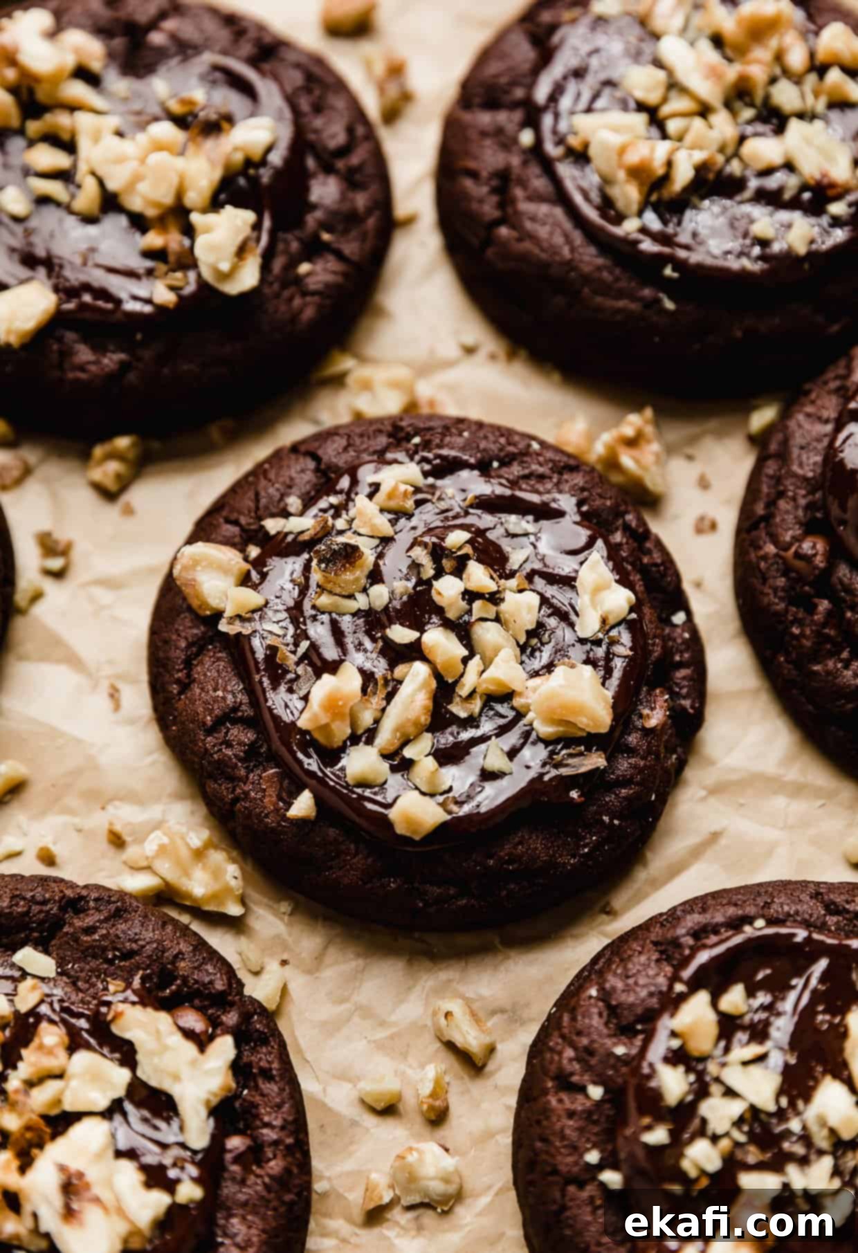 Fudgy Walnut Cookie Brownies 2 A chocolate brownie cookie topped with a melted chocolate ganache and chopped walnuts.