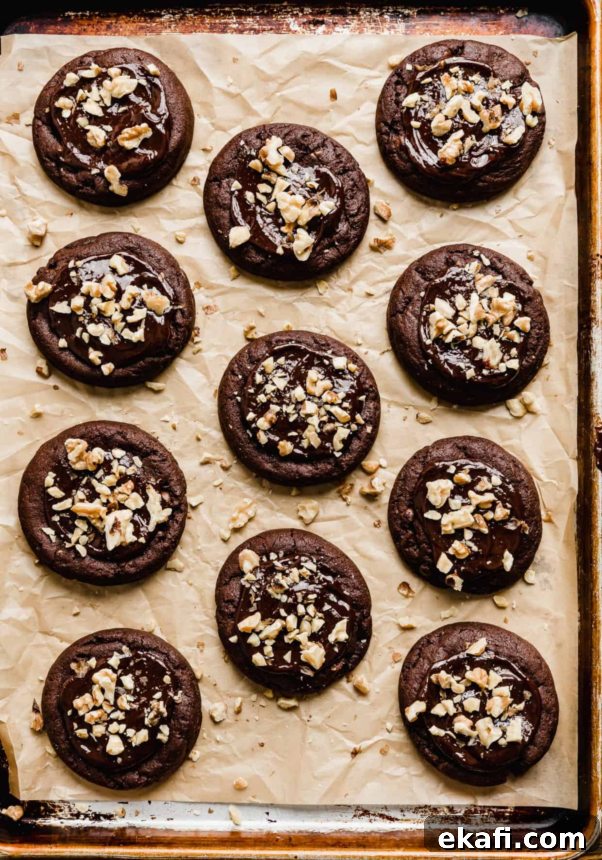 Fudgy Walnut Cookie Brownies 7 A baking sheet with Crumbl Walnut Fudge Brownie Cookies on the baking sheet.