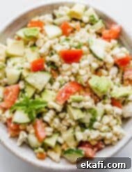 Creamy Zesty Corn Avocado Feta Salad 9 Feta Corn Salad in a bowl on a white background.