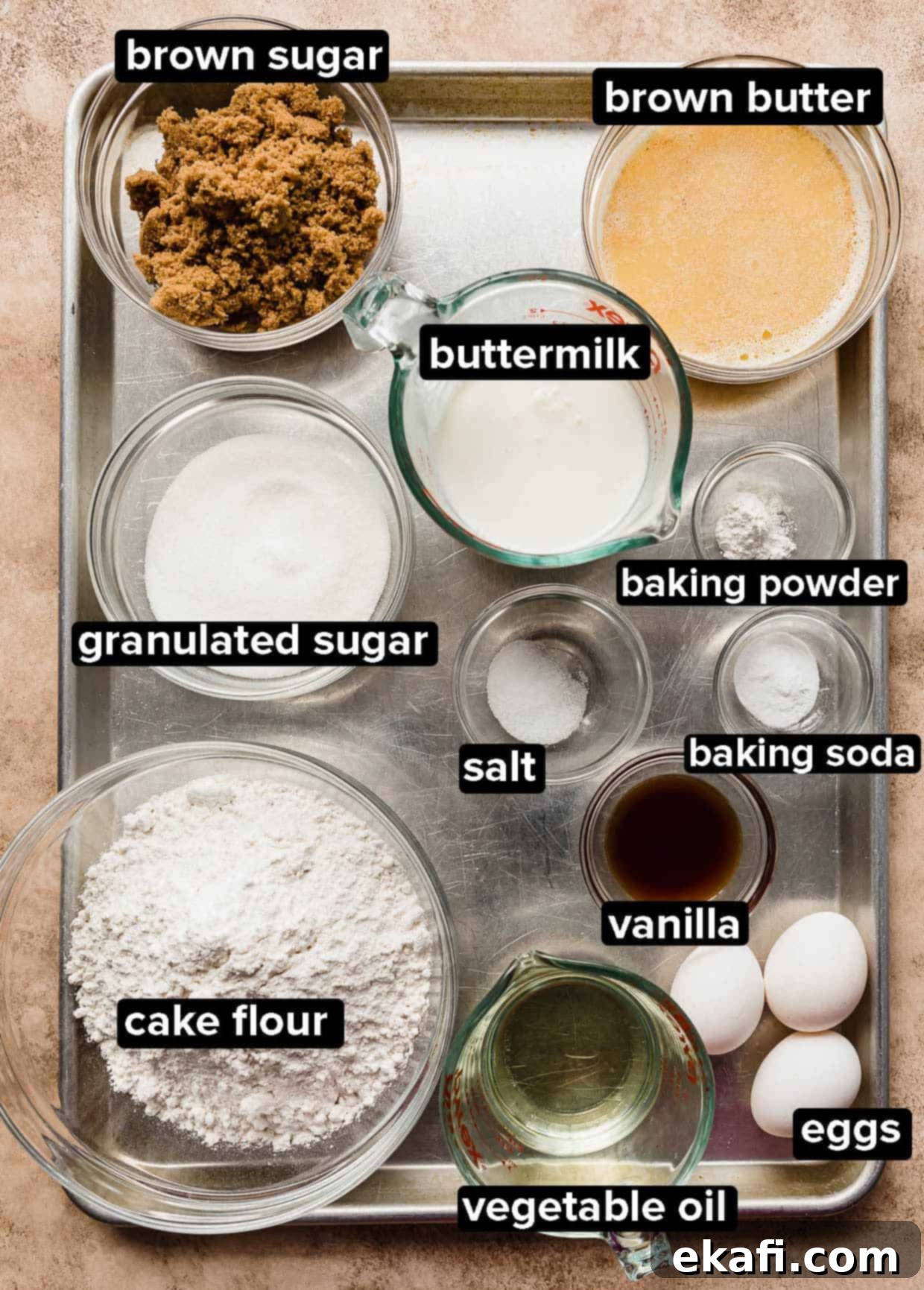 Toasted Butter Bliss 3 Brown Butter Cake ingredients portioned into glass bowls on a silver baking sheet.