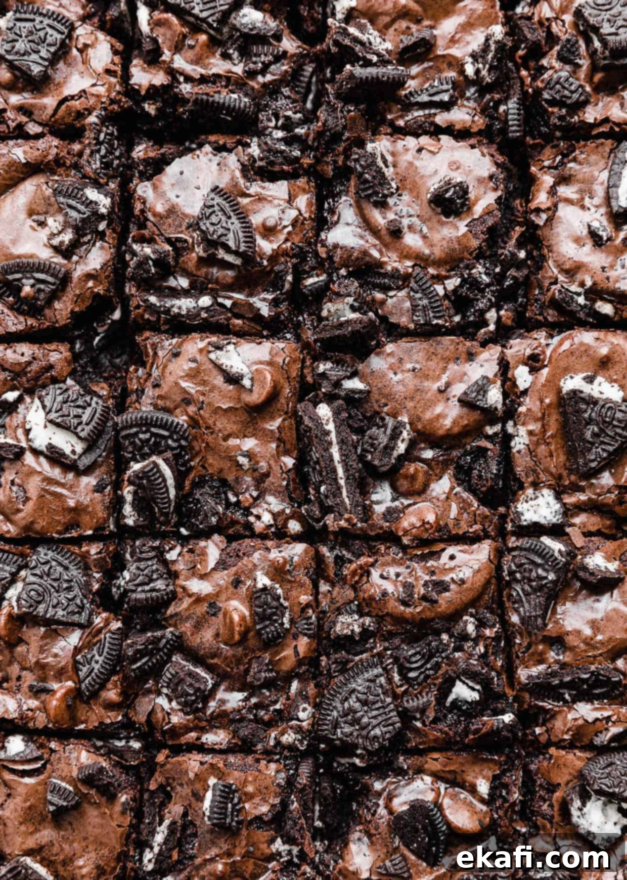 Ultimate Oreo Fudge Brownies 2 Fudgy Oreo Brownies topped with chopped Oreos cut into small squares.