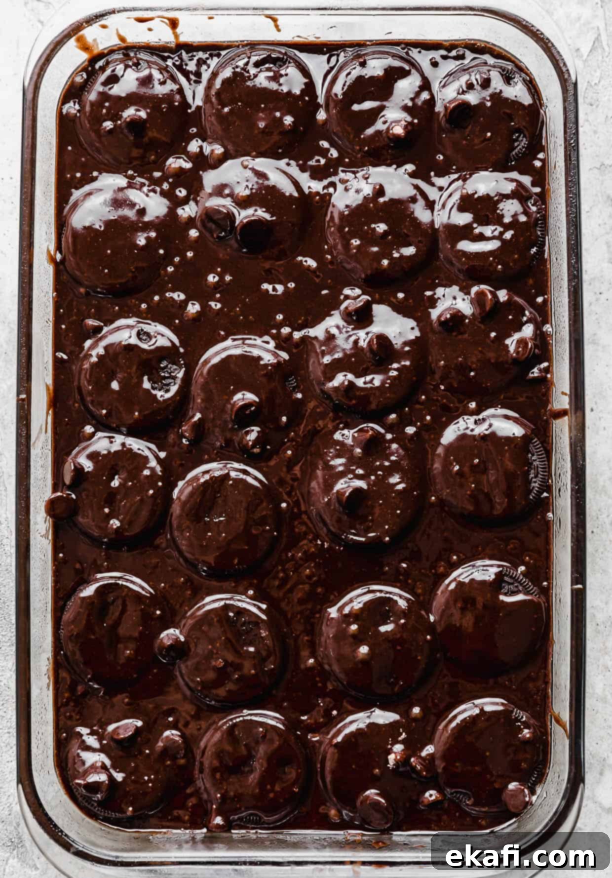 Ultimate Oreo Fudge Brownies 8 Brownie batter poured overtop Oreos in a glass rectangular pan.