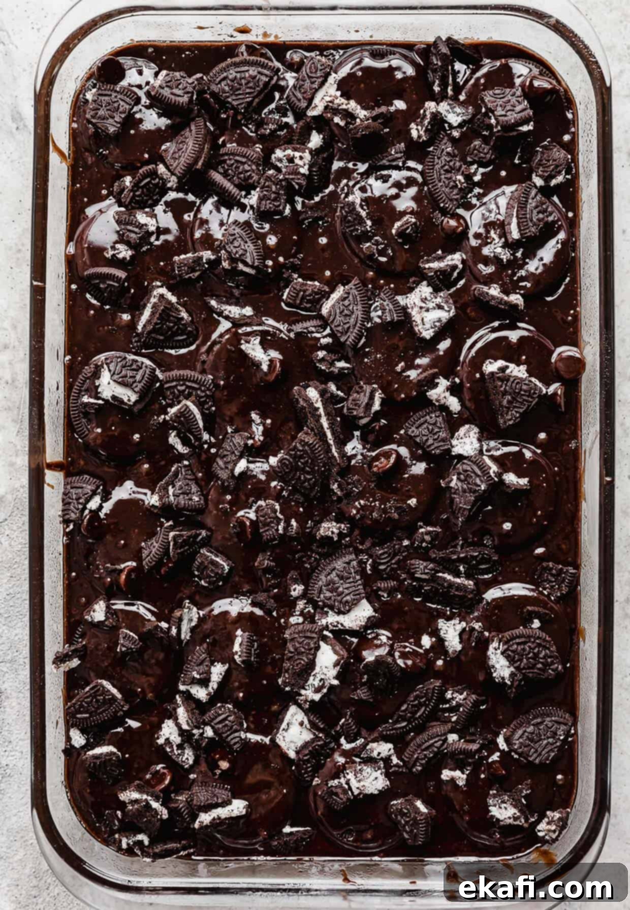 Ultimate Oreo Fudge Brownies 9 Chopped oreos sprinkled overtop brownie batter in a rectangle pan.