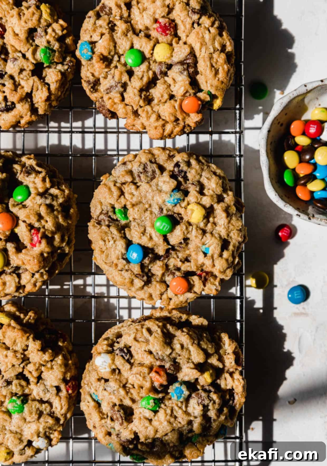 Loaded Chewy Cookies 6 Several Soft & Chewy Monster Cookies arranged on a wire cooling rack, highlighting their vibrant colors and appealing texture.
