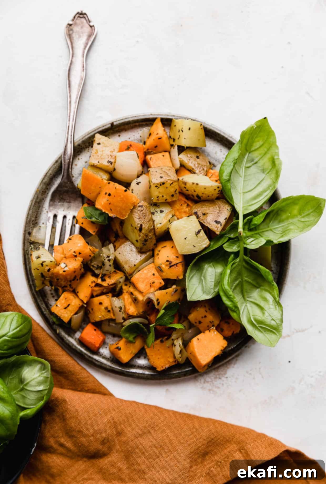 Easy Sheet Pan Root Roast 2 A gray plate on a white background with Sheet Pan Roasted Root Vegetables on the plate.