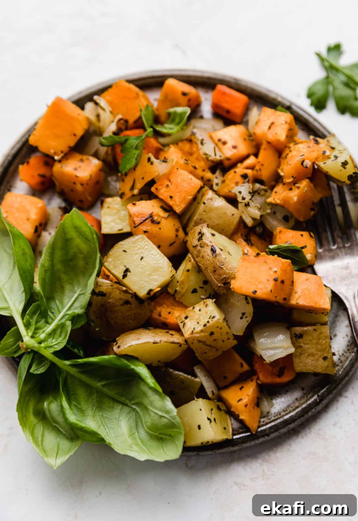 Easy Sheet Pan Root Roast 7 A close up photo of chopped roasted root vegetables on a plate.