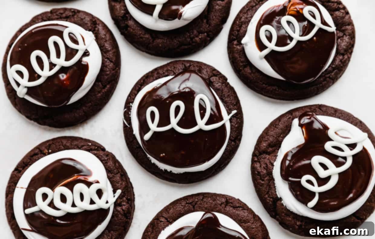 Hostess Cupcake Cookies 8 A tray of beautifully decorated Hostess Cupcake Cookies, each with a rich chocolate base, fluffy marshmallow frosting, smooth chocolate ganache, and the signature white chocolate swirls.