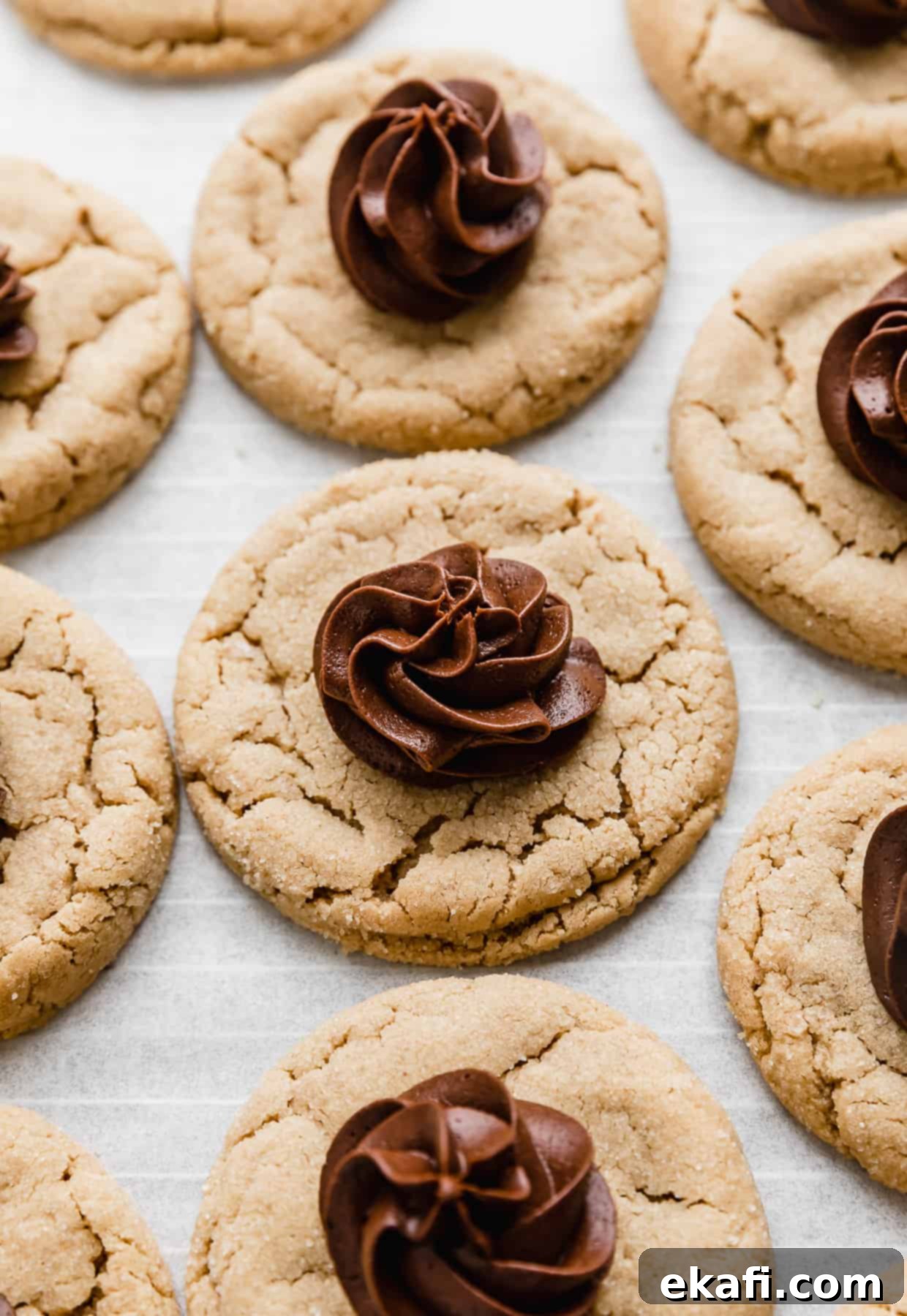 Crumbl Peanut Butter Blossoms 2 A Crumbl Peanut Butter Blossom Cookie topped with a swirl of fudge frosting.