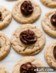 Crumbl Peanut Butter Blossoms 11 A Crumbl Peanut Butter Blossom Cookie topped with a swirl of fudge frosting.