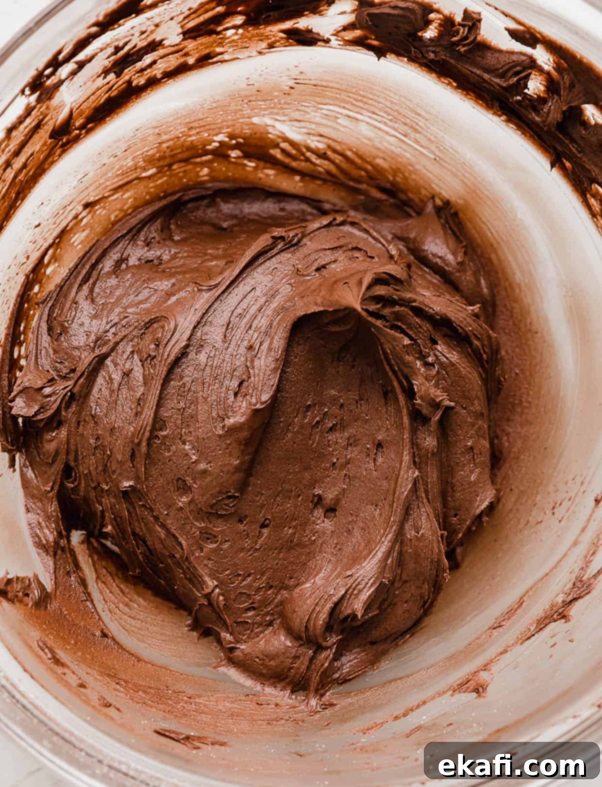 Crumbl Peanut Butter Blossoms 6 Chocolate frosting in a glass bowl.