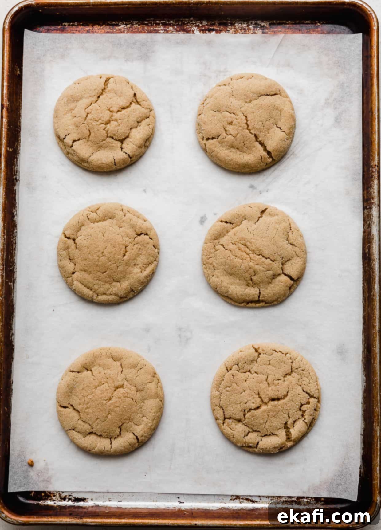 Crumbl Peanut Butter Blossoms 8 Six baked Crumbl Peanut Butter Blossom Cookies on a baking sheet.