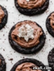 Decadent French Silk Pie Cookies 13 Crumbl copycat French silk pie cookies recipe on a white background with chocolate shavings around the cookies.