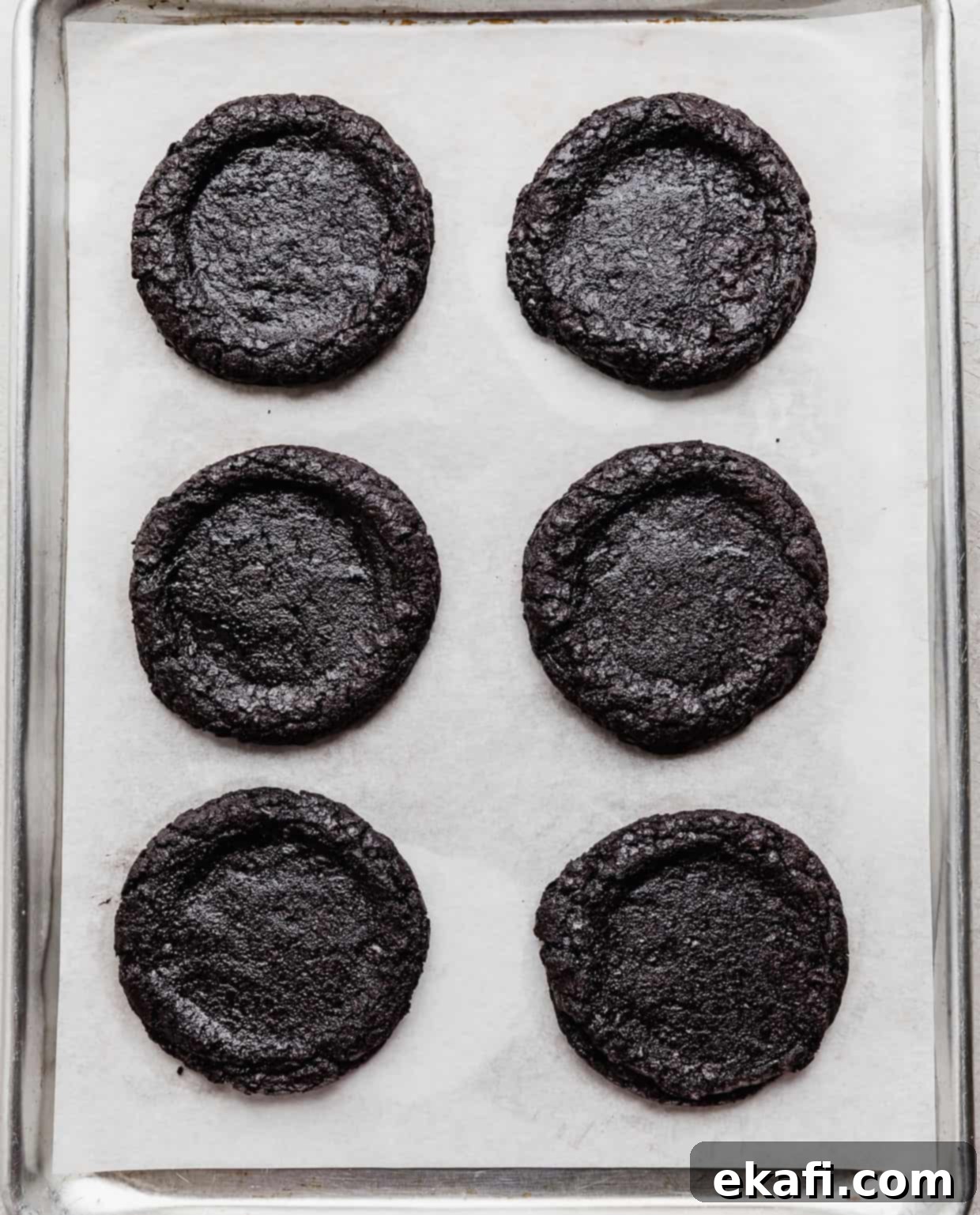 Decadent French Silk Pie Cookies 6 An Oreo cookie based French Silk Pie Cookie on a white parchment paper lined baking sheet.