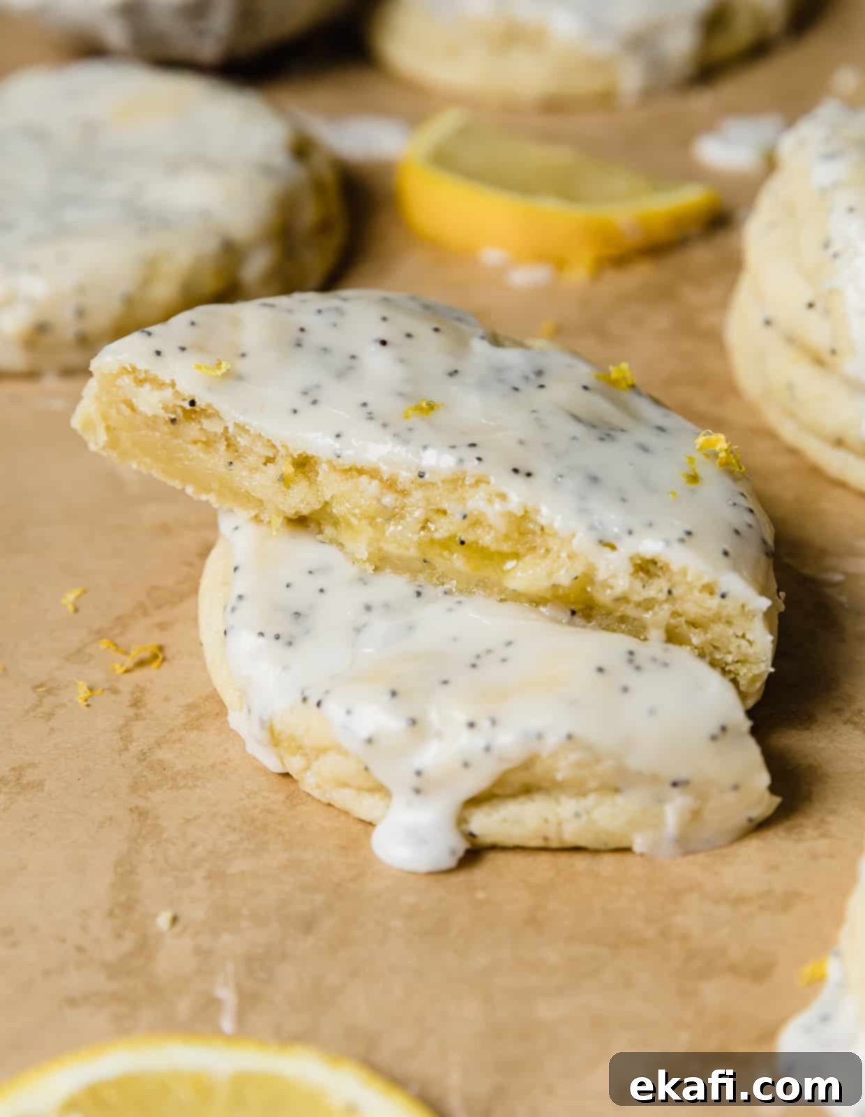 Zesty Lemon Poppy Seed Delights 14 Lemon curd cookies with poppy seeds, cut in half showing the lemon curd in the center.
