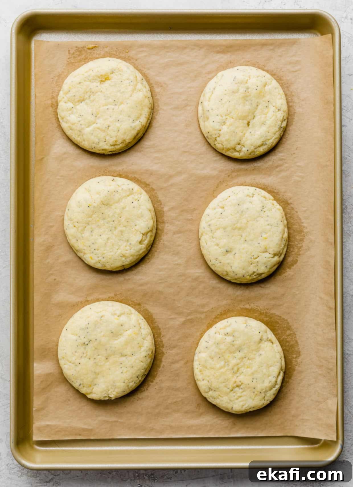 Zesty Lemon Poppy Seed Delights 10 Six Crumbl copycat Lemon Poppy Seed Cookies with lemon curd filling, on a baking sheet.