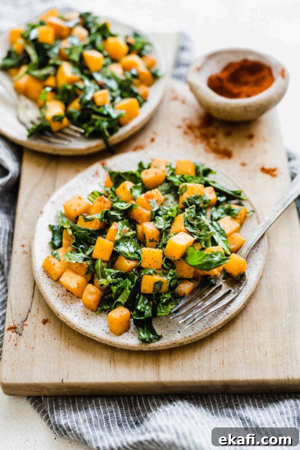 Roasted Butternut Squash and Kale 2 Butternut Squash and Kale on a white plate, ready to be served.