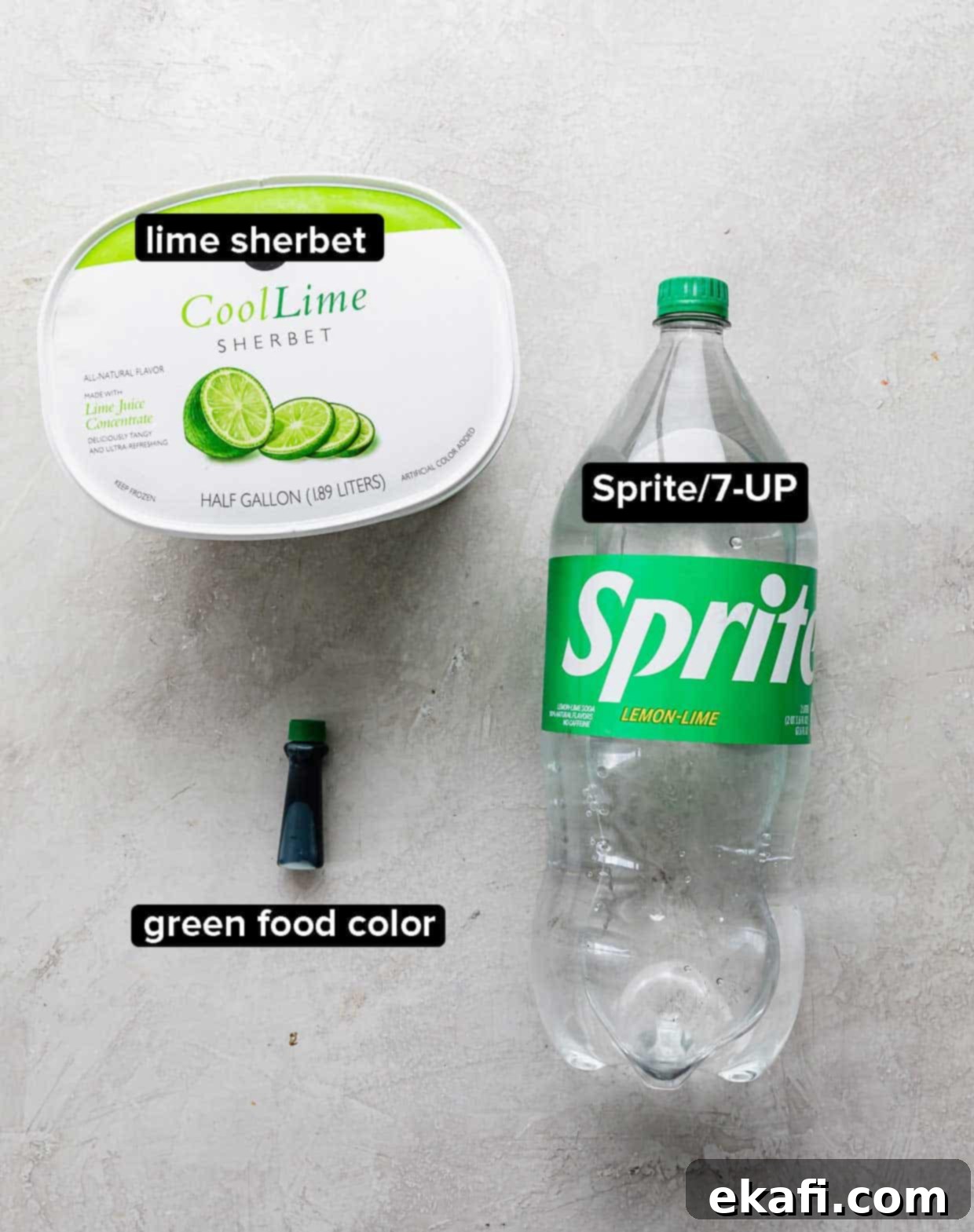 Shape-Shifter's Brew 3 A flat lay photograph showcasing the three simple ingredients for Polyjuice Potion: creamy lime sherbet, a bottle of green food coloring, and a can of Sprite on a grey background.