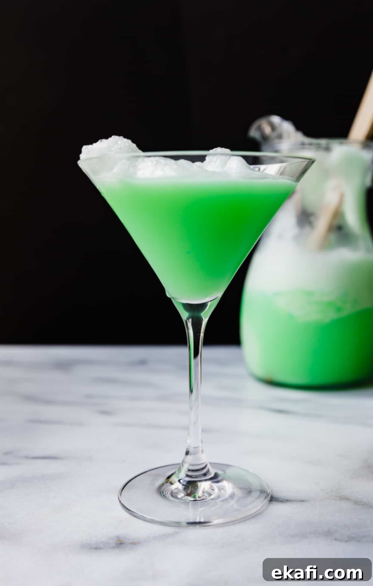 Shape-Shifter's Brew 7 A vibrant green Polyjuice Potion served in a festive margarita glass, glowing against a mysterious black background.