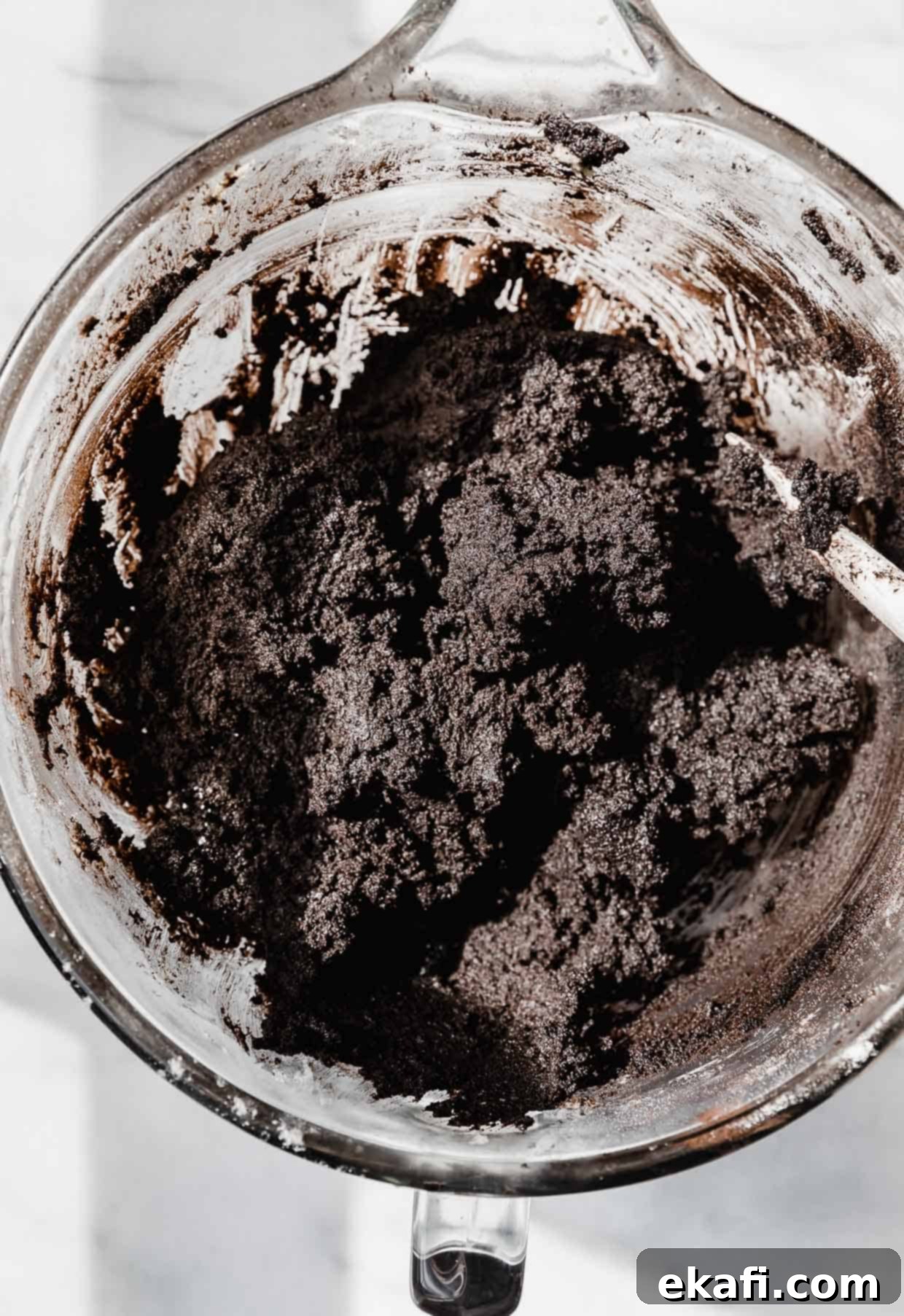 Oreo Mud Pie Cookies 5 Black oreo cookie dough in a glass mixing bowl.