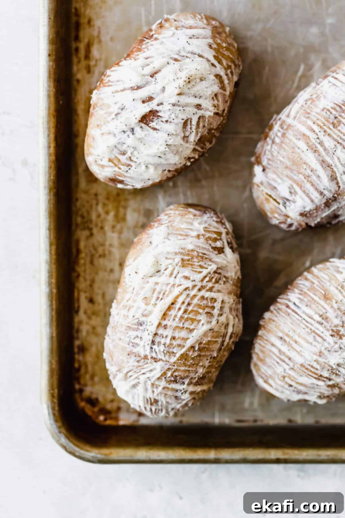 Crispy Air Fryer Hasselback Potatoes 3 Softened butter spread over russet potatoes topped with salt and pepper.