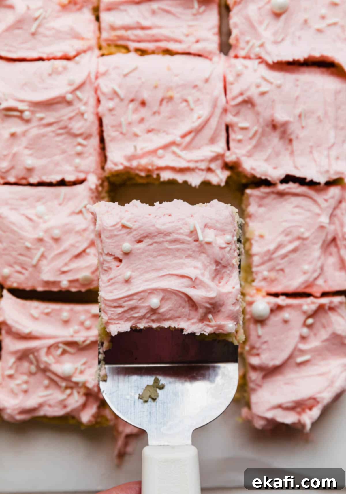 Frosted Sugar Cookie Bars 2 Cut sugar cookie bars topped with pink buttercream frosting, ready to serve.