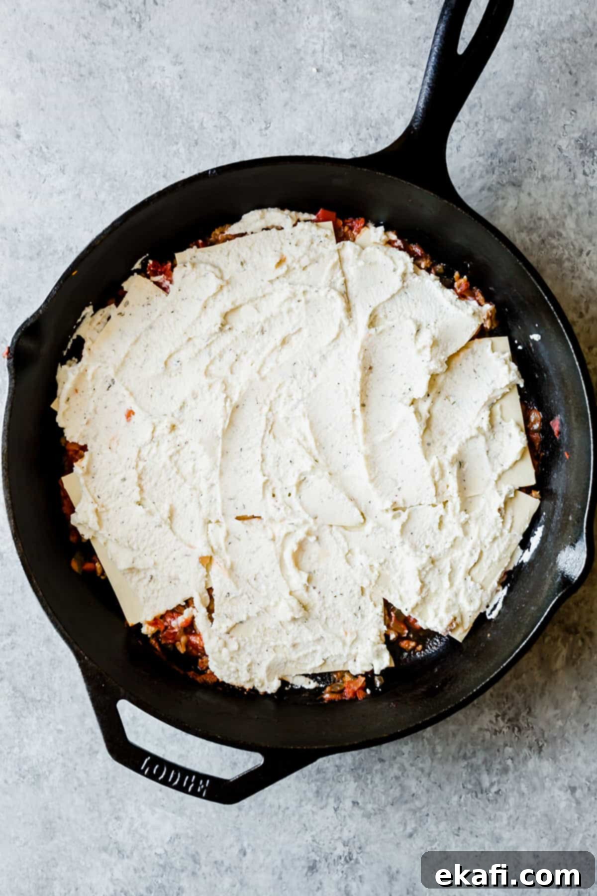 Rustic Cast Iron Lasagna 7 Ricotta mixture spread over no boil noodles, making a cast iron skillet lasagna.