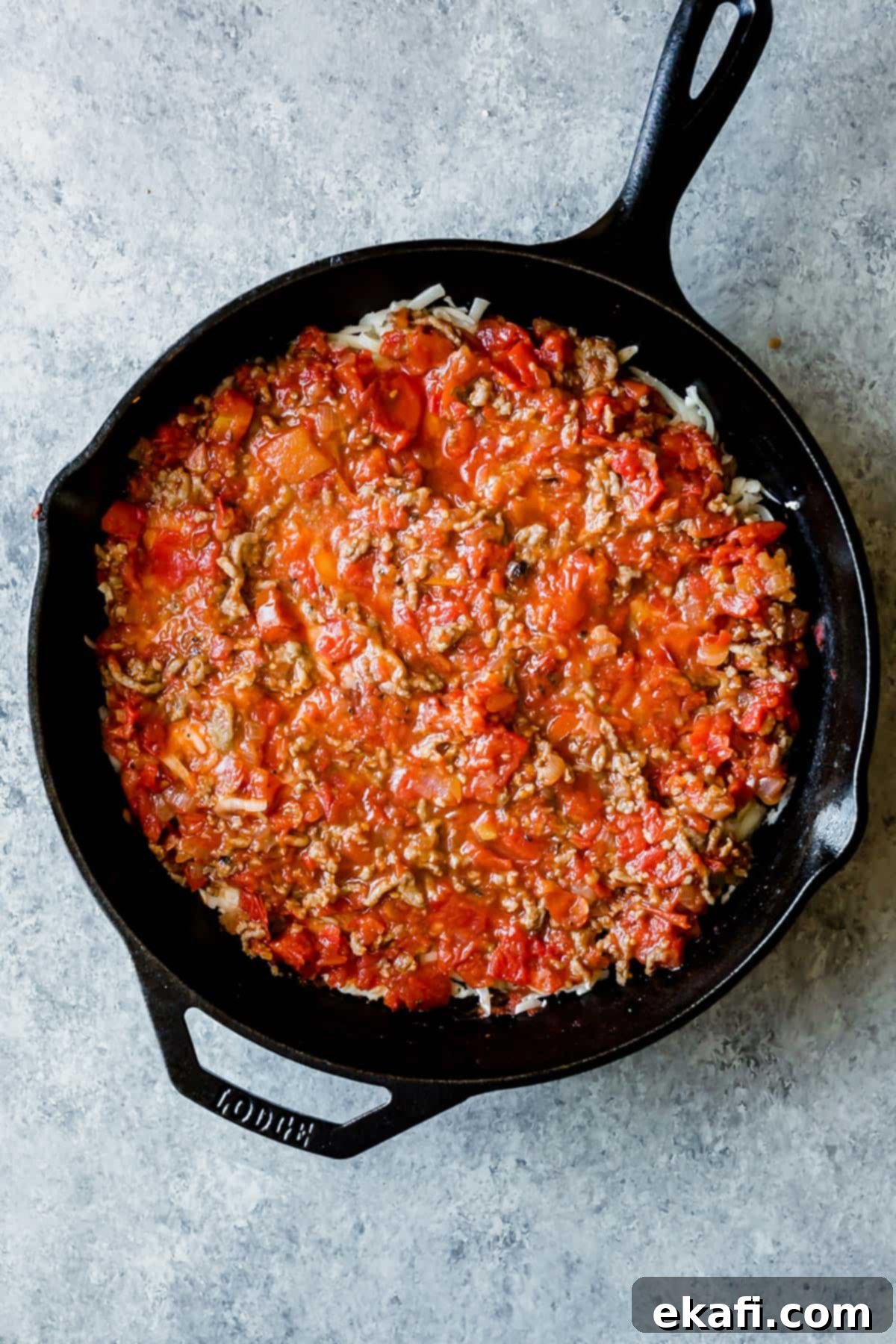 Rustic Cast Iron Lasagna 9 A cast iron skillet with a Cast Iron Lasagna mixture in it.