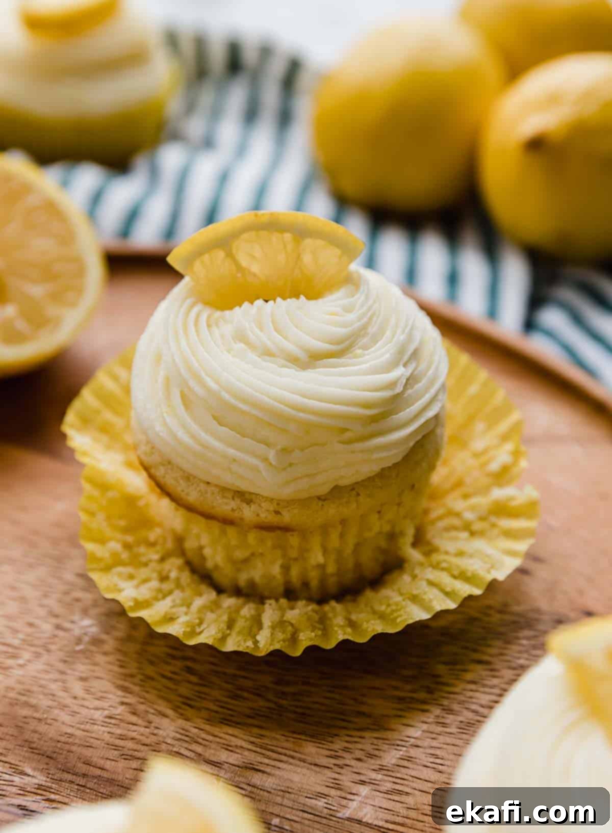 Zesty Lemon Cupcakes 2 Lemon Cupcake on a wood plate.