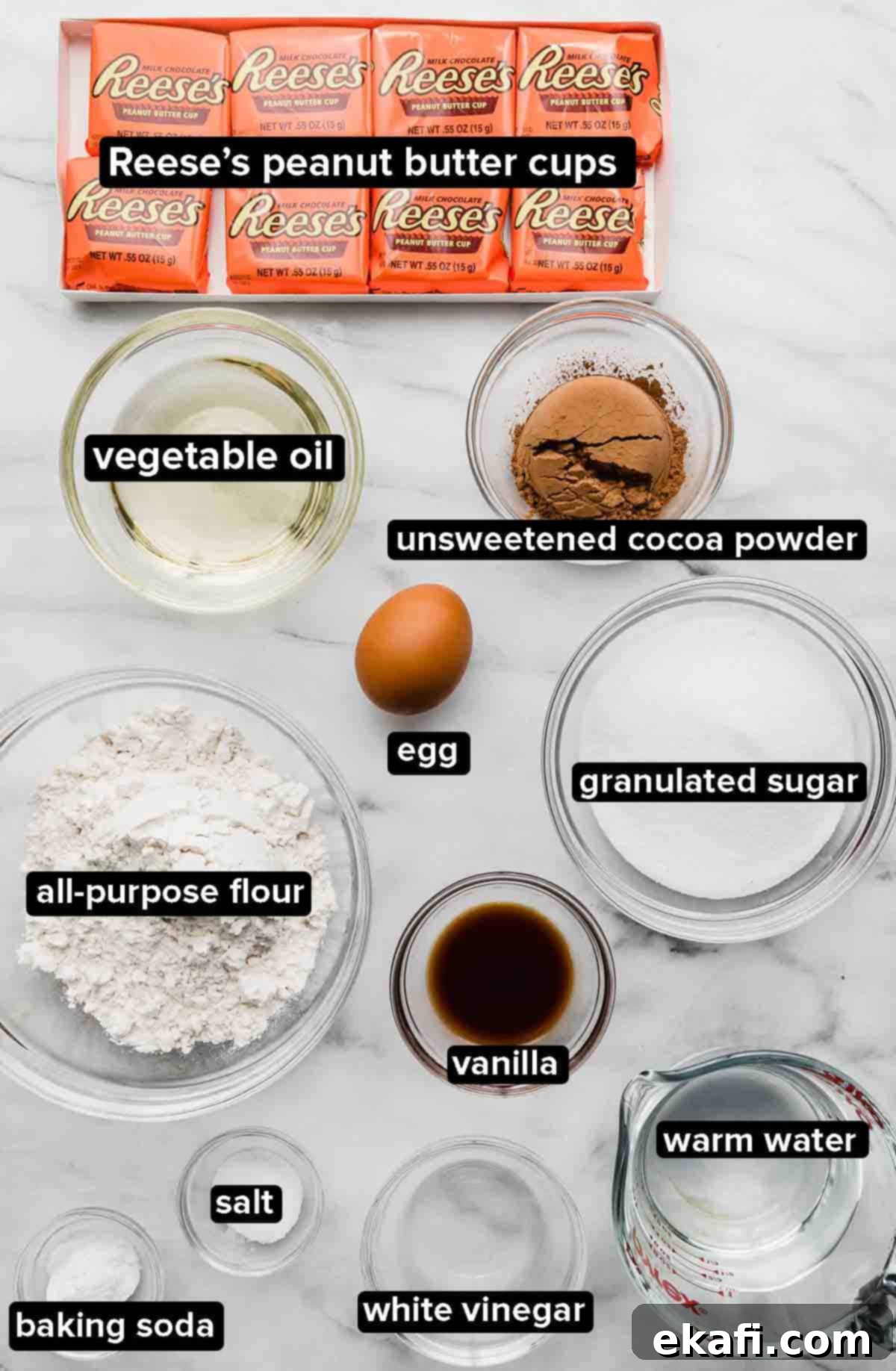 Reeses Peanut Butter Cupcakes 3 Reeses peanut butter Cupcake ingredients portioned into glass bowls on a white marble background.