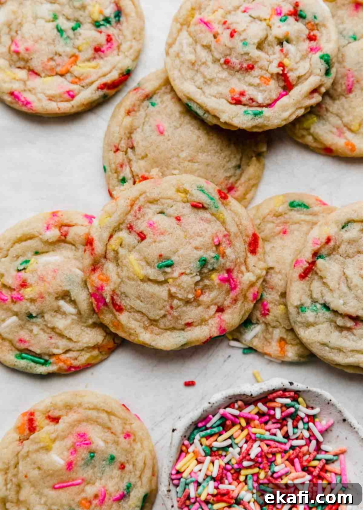Celebration Cookies 6 A close-up shot of several soft and festive Funfetti Cookies arranged neatly on a crisp white background, highlighting their tender texture and colorful sprinkles.
