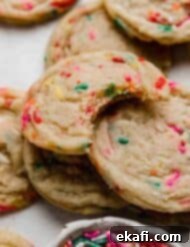 Celebration Cookies 8 A delicious Funfetti Cookie with a bite taken out, showcasing its soft interior and vibrant sprinkles.