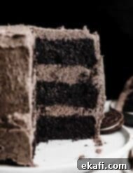 Decadent Oreo Dream 9 A three layer six inch Oreo Cake recipe topped with an Oreo frosting, against a black background.