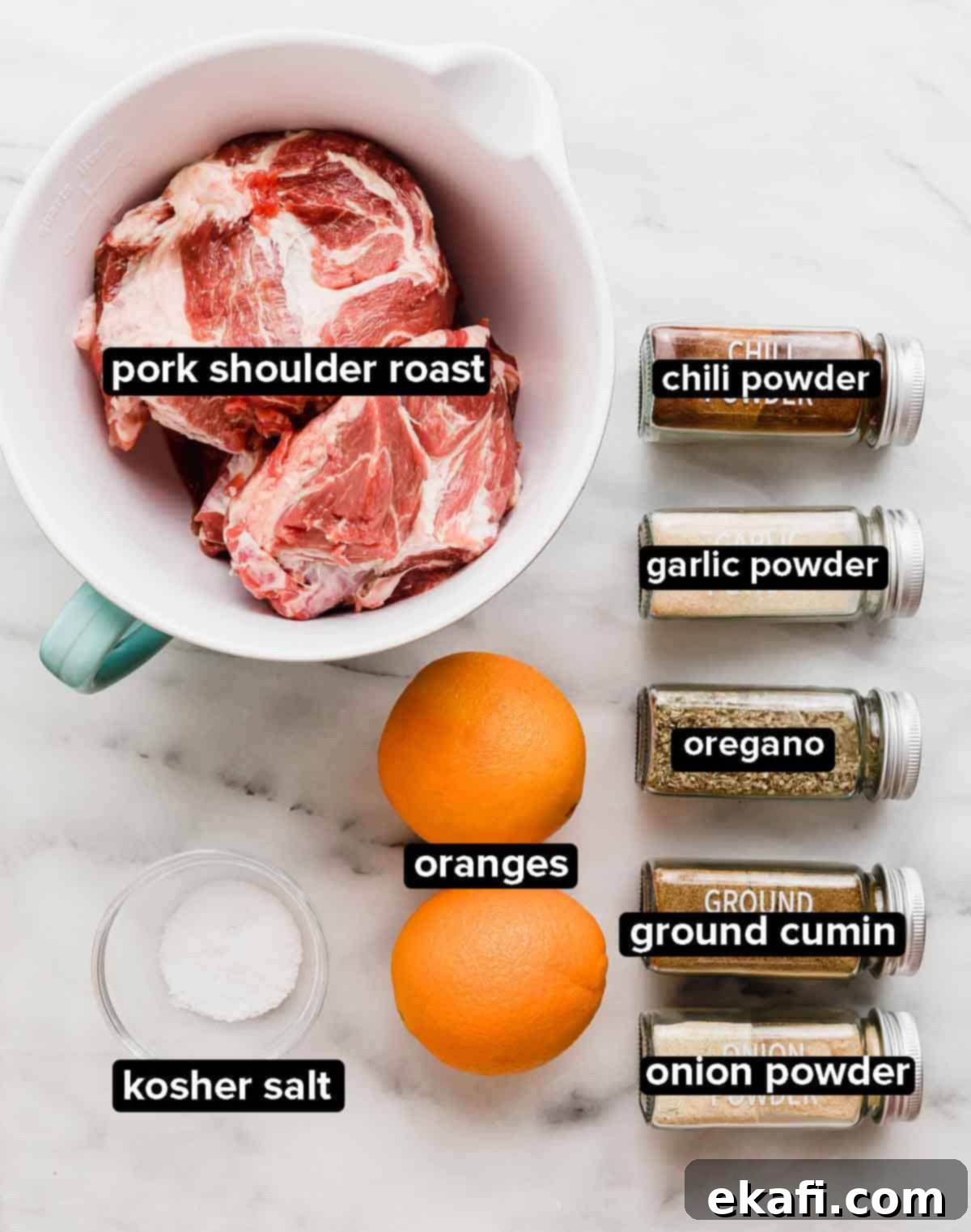 Carnitas 3 Ingredients used to make Mexican Pulled Pork carnitas on a white background: pork butt, oranges, salt, chili powder, cumin, oregano, onion powder, and garlic powder.