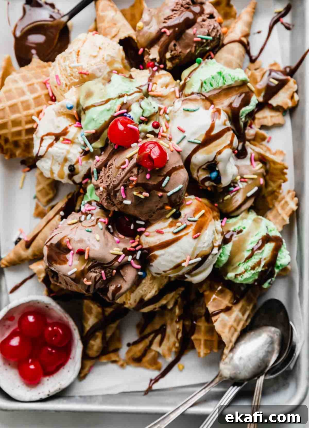 The Sweet Scoop Fiesta 6 Close up of Ice Cream Nachos topped with hot fudge, butterscotch sauce, sprinkles, and maraschino cherries.
