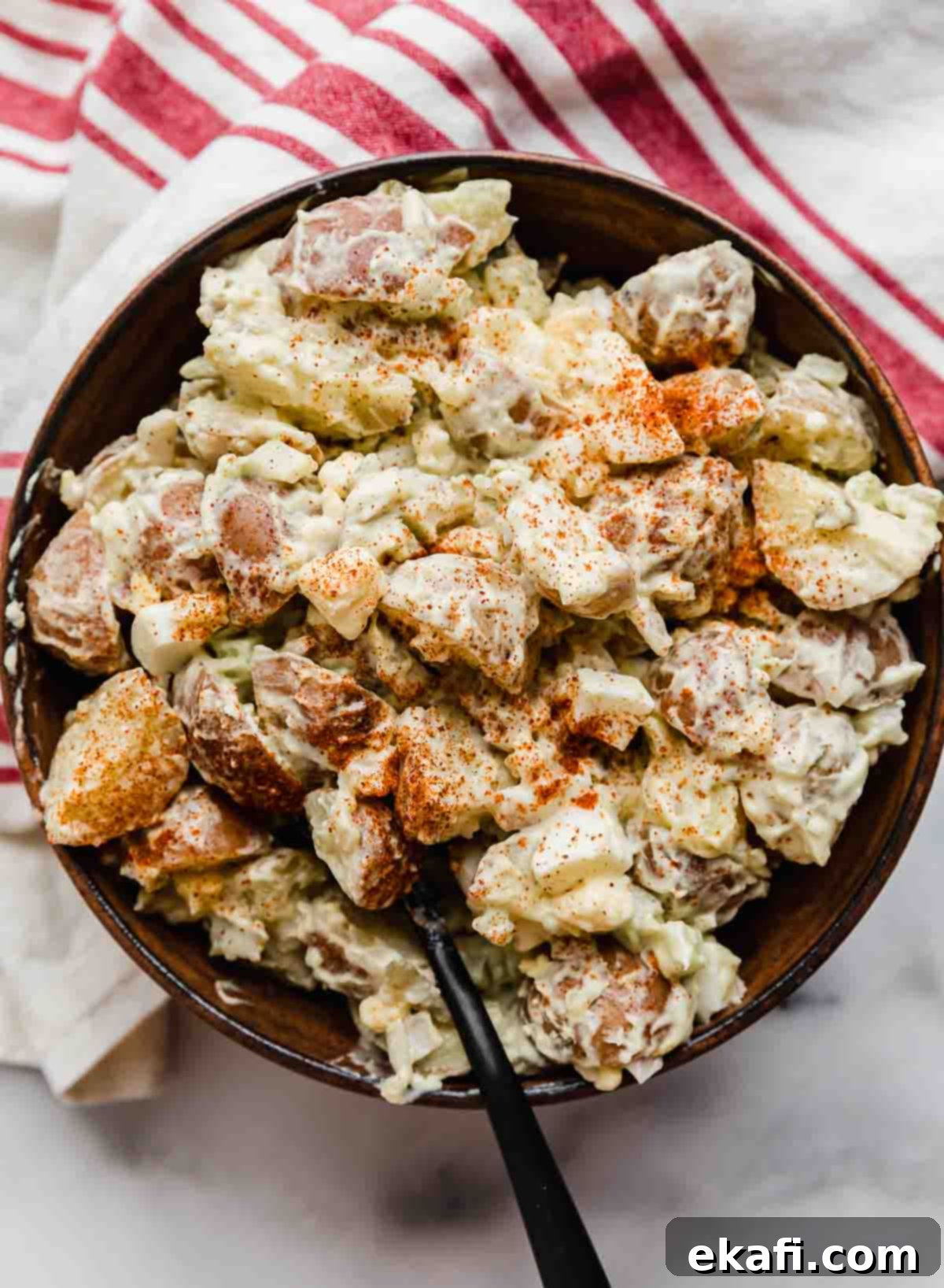 Homestyle Baby Potato Salad 2 Potato Salad with sweet relish in a brown bowl on a marble background.