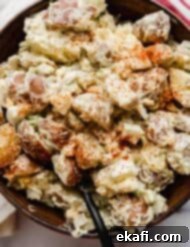 Homestyle Baby Potato Salad 7 Close up photo of red and Yukon gold baby potato salad in a brown bowl.