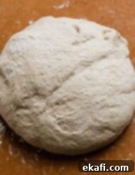 Flawless Pizza Dough Every Time 7 A perfectly shaped ball of pizza dough, ready to be rolled out.